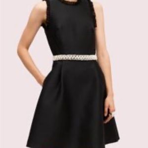 Kate Spade black dress belted with pearls.